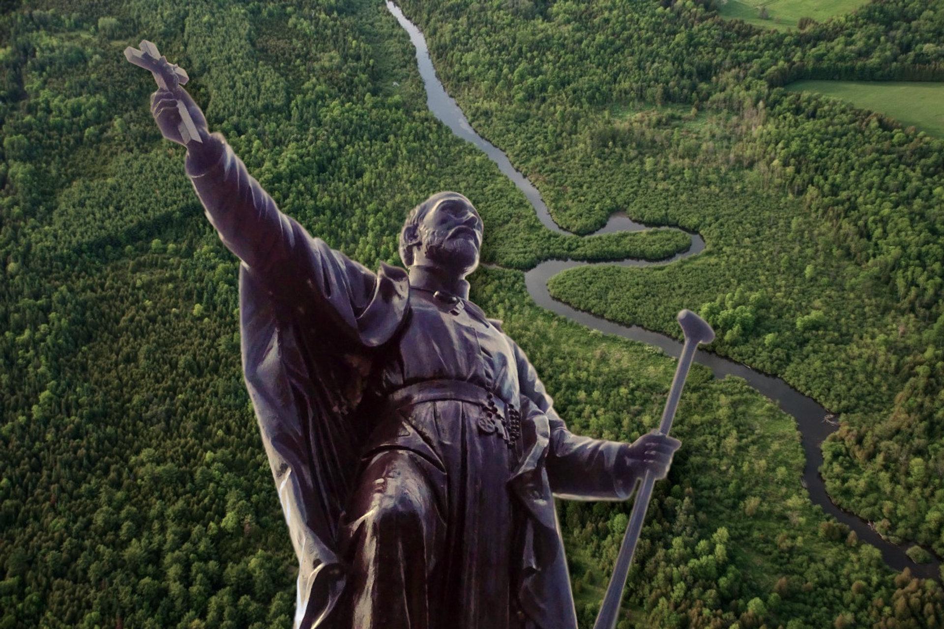 St. Jean de Brebeuf statue against Canadian wilderness.
