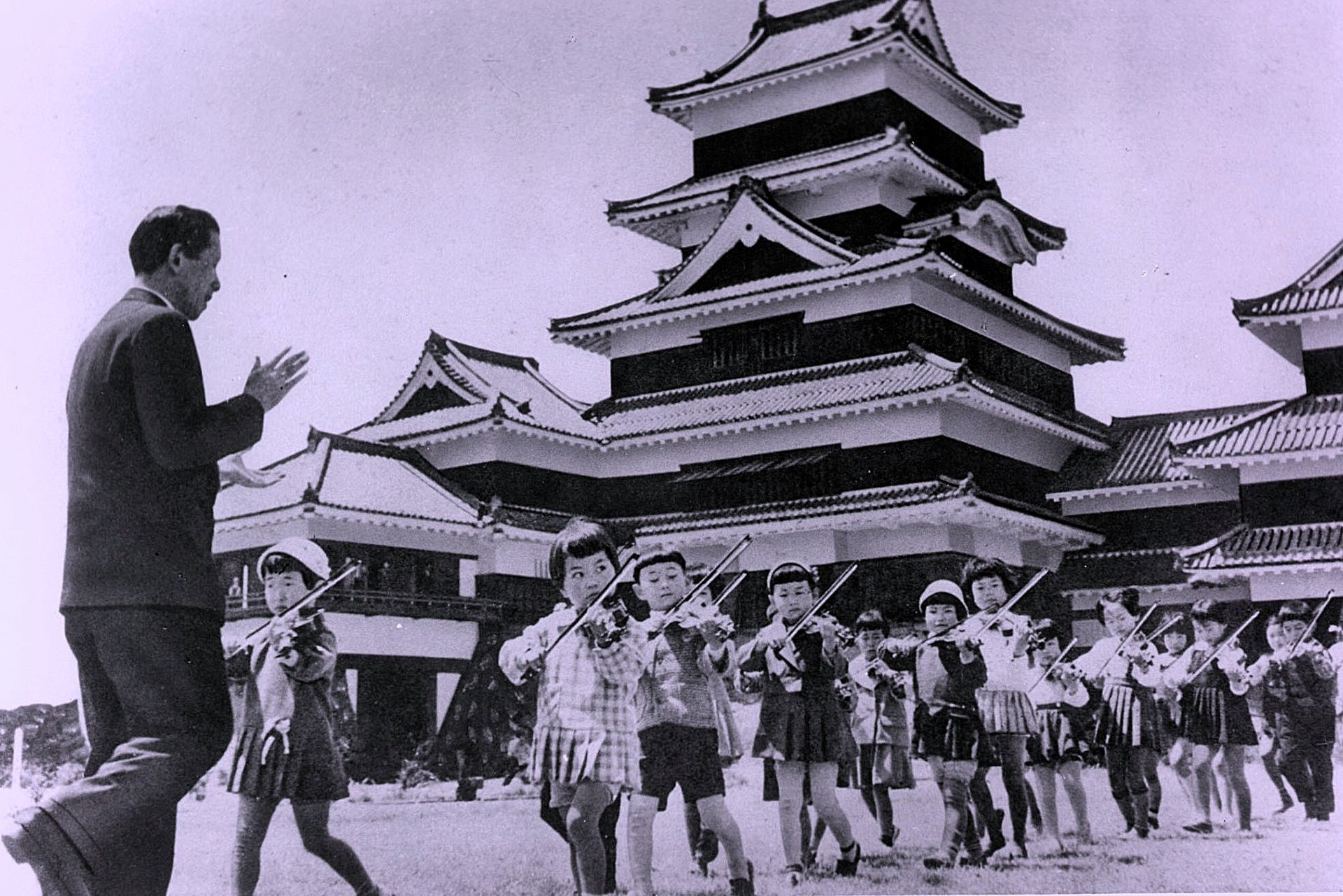 Shinichi Suzuki gives a music lesson outside Matsumoto Castle in Japan