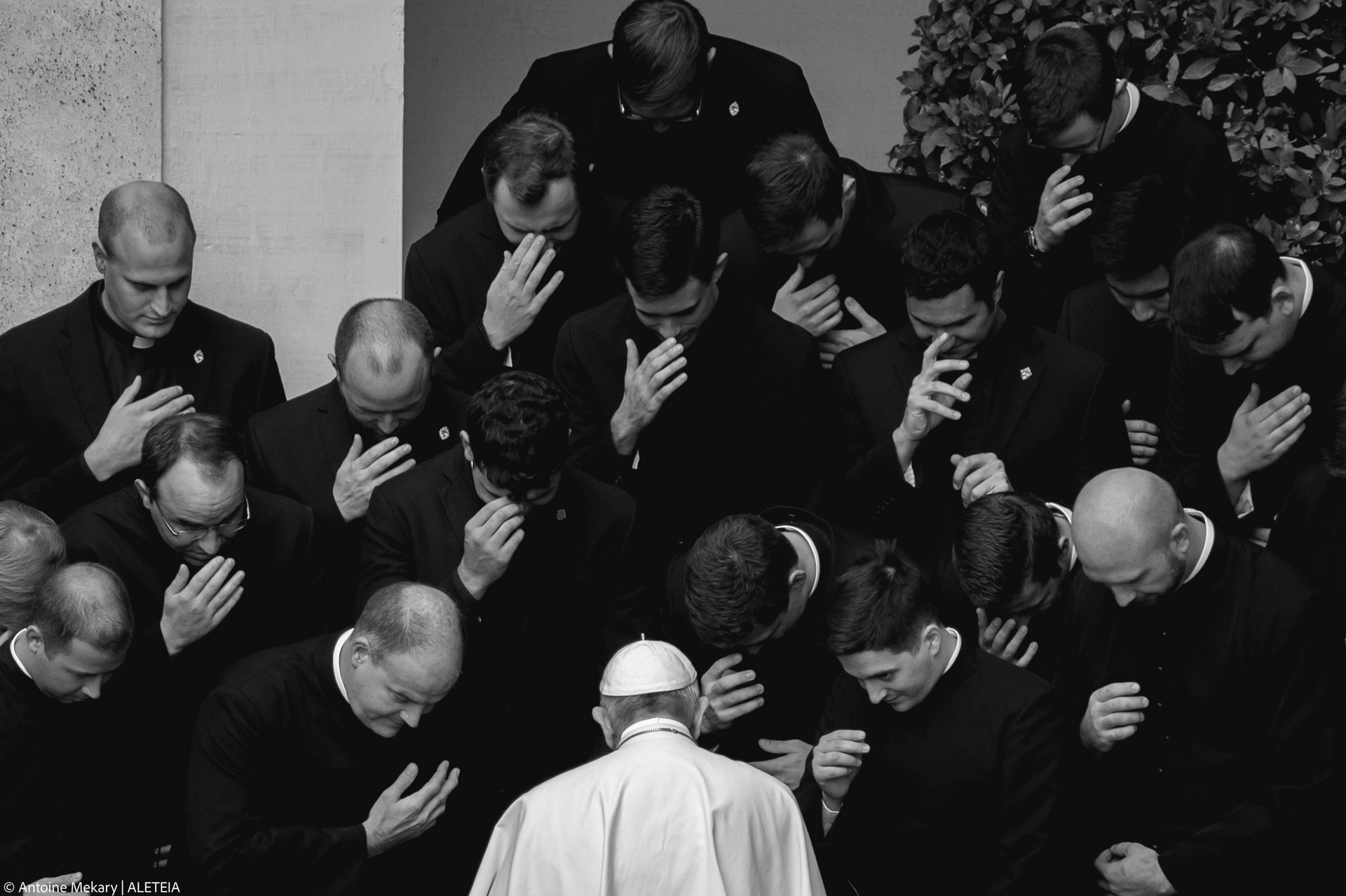 Pope Francis prays with priests at the end of a limited public audience at the San Damaso courtyard in The Vatican on September 30, 2020 during the COVID-19 infection