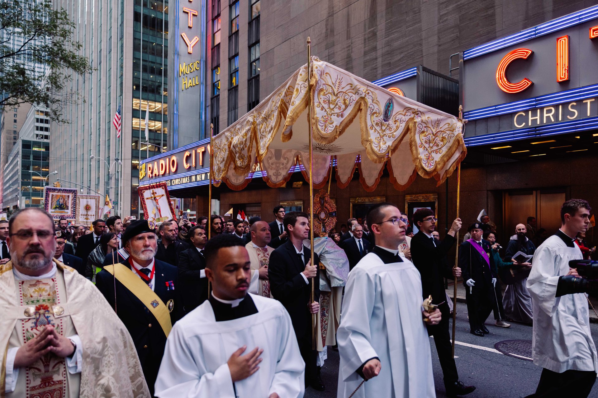 Priests bringing Eucharist by Radio City Music Hall