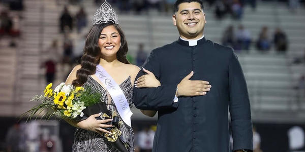 Priest escorts Homecoming Queen — and crowds love it!