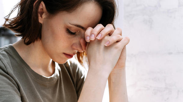 WOMAN PRAYS,