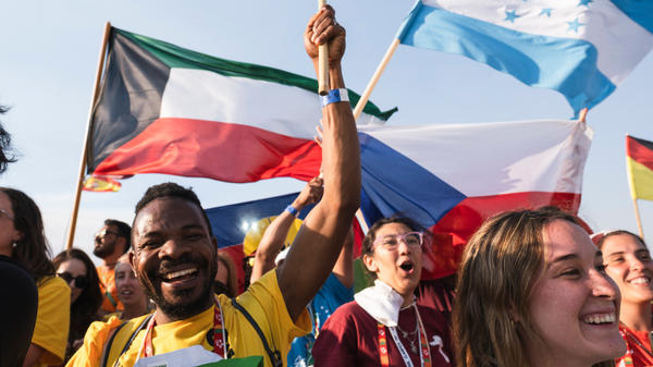 Pilgrims pray during the World Youth Days vigil with young people in Tejo Park, Lisbon