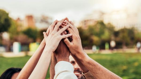Community of millennial people stacking hands together - Community-of-millennial-people-stacking-hands-together-shutterstock_2449105615-1.jpg