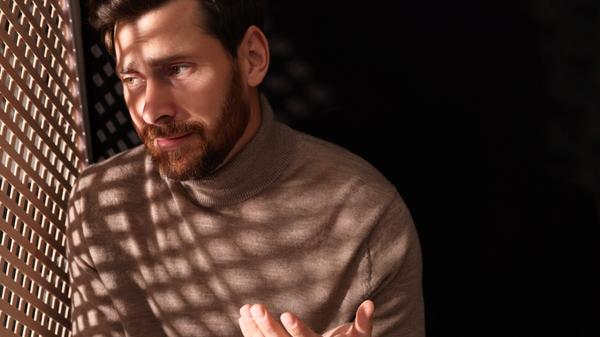 Man talking to priest during confession in booth, space for text