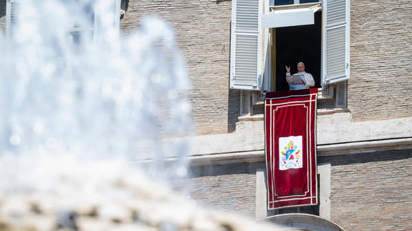 Pope Leo XIV blesses the crowd from a window of the apostolic palace overlooking St Peter's Square during the Angelus prayer in The Vatican on June 21, 2026.