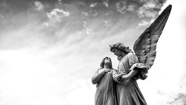 WOMAN WITH ANGEL SCULPTURE