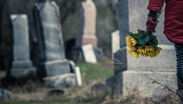 WOMAN,FLOWERS,CEMETERY