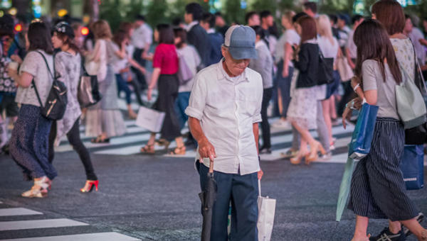 MAN CROSSING THE SHIBUYA SCRAMBLE