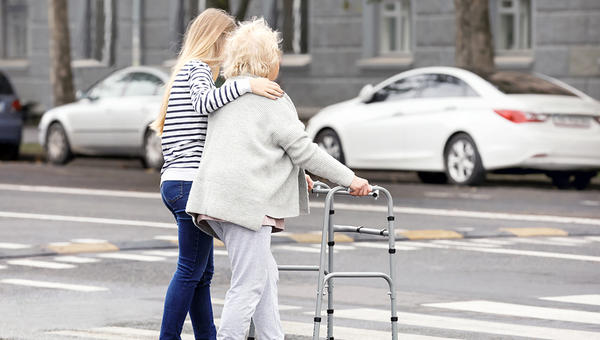 WOMAN HELPING ELDERLY
