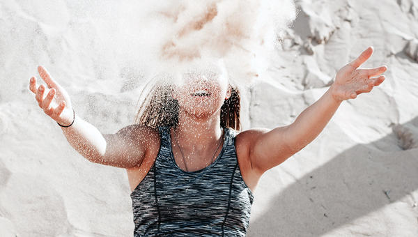 WOMAN THROWING SAND