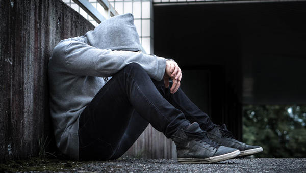 MAN SITTING,HEAD DOWN