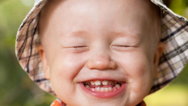 child smiles with teeth