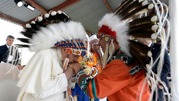 Pope Francis wearing a headdress Indigenous leaders at Muskwa Park in Maskwacis, Edmonton