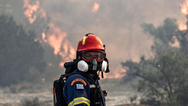 A firefighter looks on during a fire near the village of Vati, just north of the coastal town of Gennadi, in the southern part of the Greek island of Rhodes on July 25, 2023.