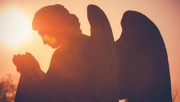 guardian angel sculpture at sunset