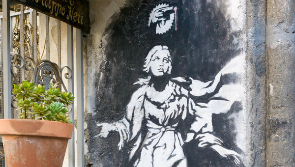 Madonna z pistoletem - obraz Banksy'ego na ścianie budynku w Neapolu