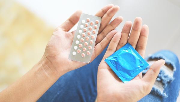 Contraceptives condom pills hands