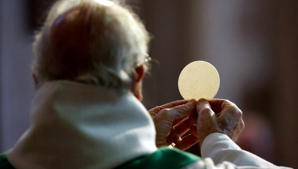 Sacerdote consagrando a Eucaristia