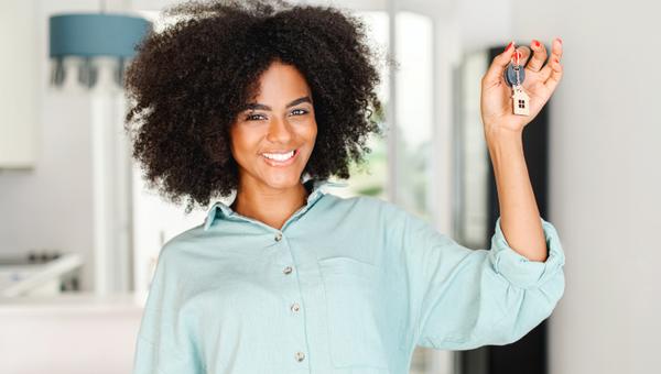 woman holding up keys