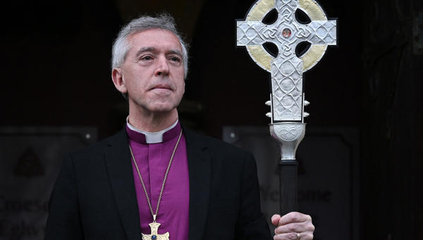 Archbishop of Wales, Andrew John poses with 'The Cross of Wales' ahead of a ceremony to bless the Cross at Holy Trinity Church in Llandudno