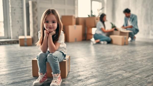 Family on moving day. Couple with their cute little daughter are happy to move into new home