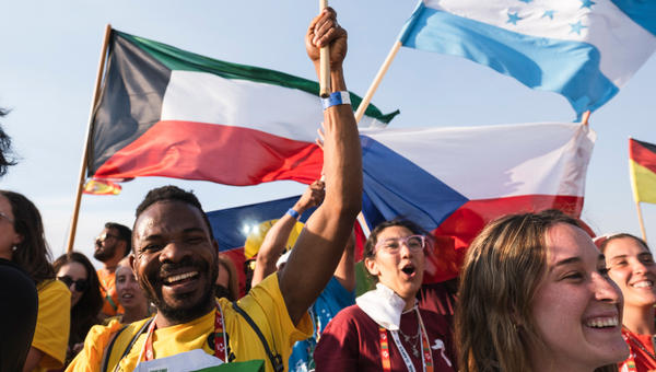 Pilgrims pray during the World Youth Days vigil with young people in Tejo Park, Lisbon