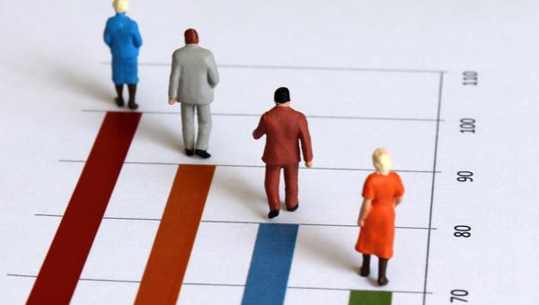 miniature figures walk along graph representing years of age