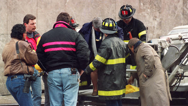 Emergency workers attend person injured in World Trade Center attack