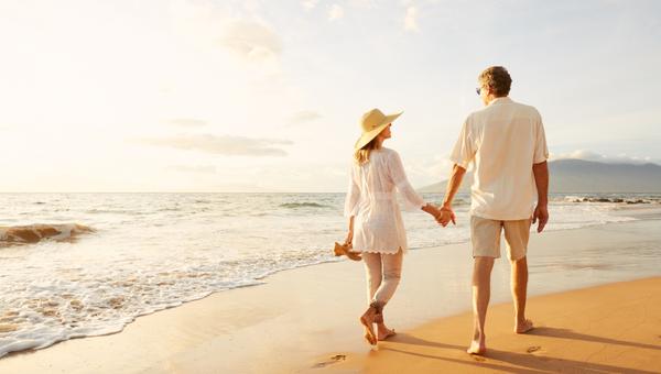 Happy Romantic Middle Aged Couple Enjoying Beautiful Sunset Walk on the Beach