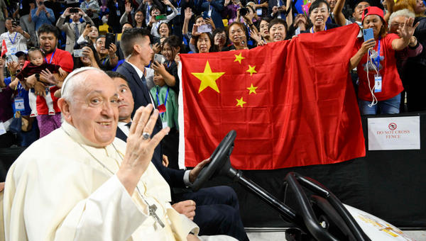 Pope Francis being driven past a Chinese flag during his arrival for Holy Mass at the Steppe Arena in Ulaanbaatar