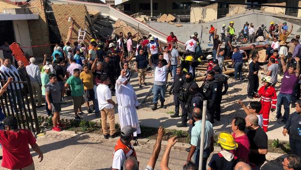 Priest and volunteers help rescue people at Mexico church collapse