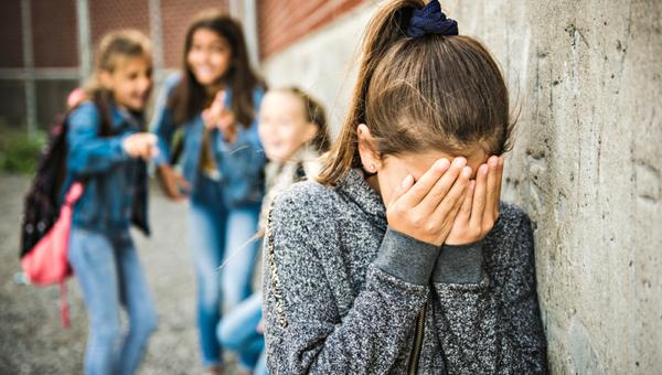 A sad girl intimidation moment on the elementary Age Bullying in Schoolyard
