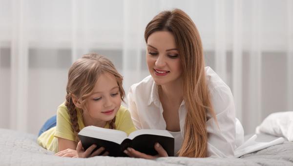 Girl and woman reading the Bible