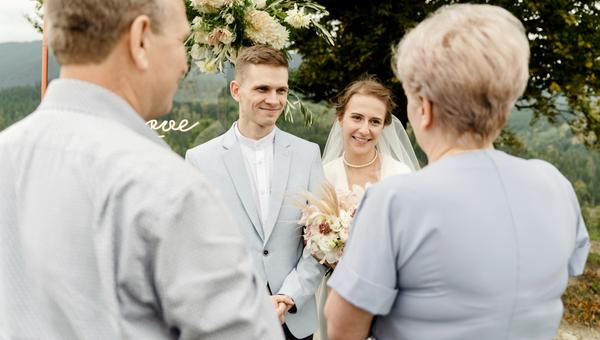 elderly parents with a young wedding couple after a wedding ceremony