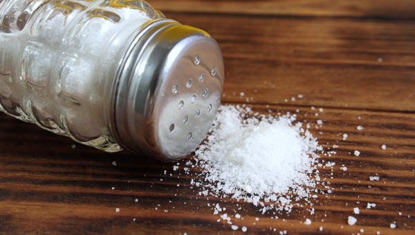Saltshaker and salt on table
