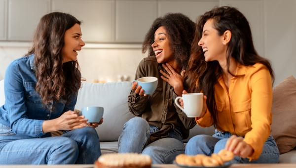 3 women laughing and conversing