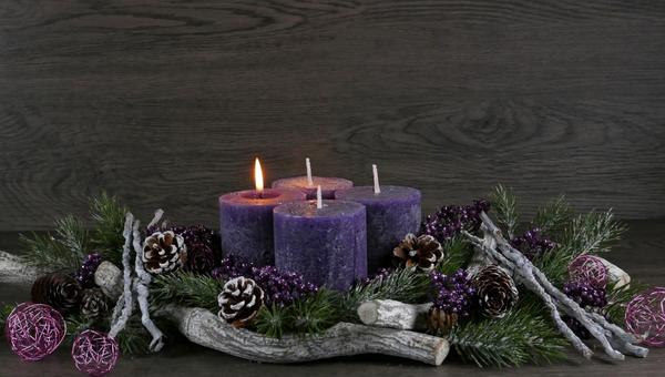 Advent wreath with a purple burning candle for the first Advent