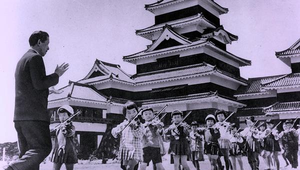 Shinichi Suzuki gives a music lesson outside Matsumoto Castle in Japan