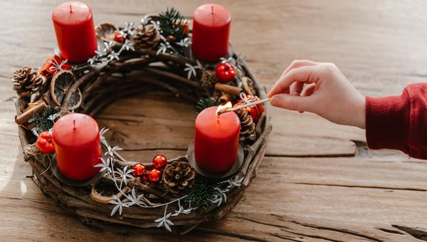 First candle on advent wreath made with branches