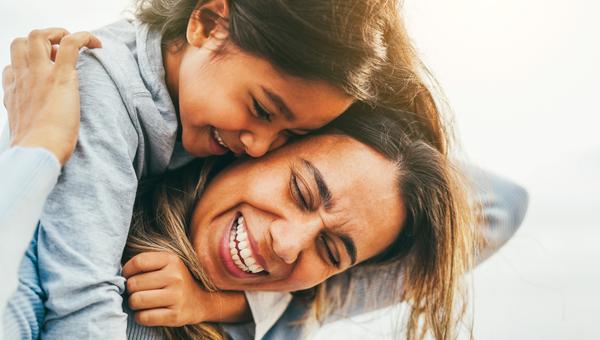 Happy mom with daughter on back