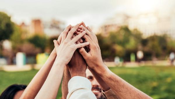 Community of millennial people stacking hands together - Community-of-millennial-people-stacking-hands-together-shutterstock_2449105615-1.jpg