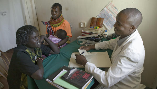 A doctor in Kenya counsels a woman about HIV