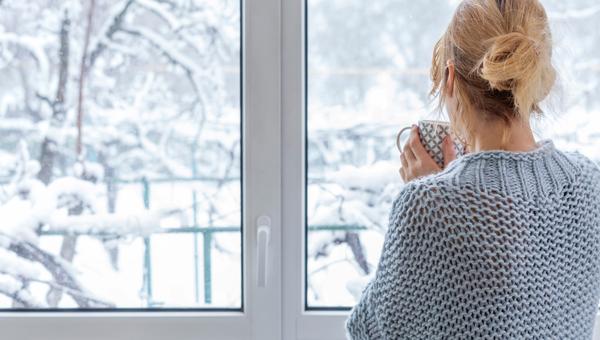 Looking out at snow with coffee