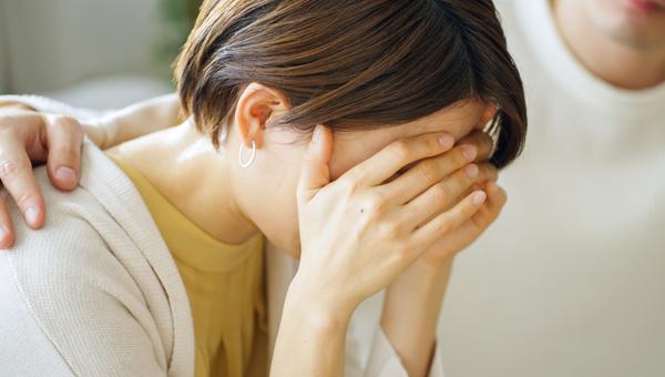 Woman who is upset comforted by husband