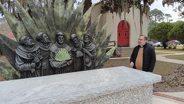 Fr. Pablo Migone in front of Georgia Martyrs sculpture