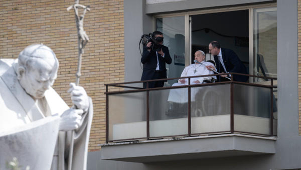 Pope Francis waves from a window of the Gemelli hospital before to be discharge after a five weeks hospitalization for pneumonia, in Rome on March 23, 2025