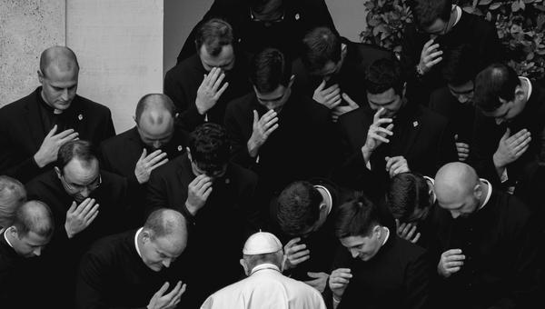 Pope Francis prays with priests at the end of a limited public audience at the San Damaso courtyard in The Vatican on September 30, 2020 during the COVID-19 infection