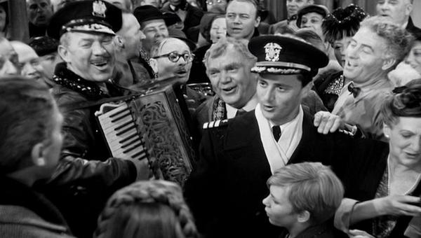 Ward Bond on accordion, Charles Halton (in round glasses), Thomas Mitchell, Todd Karns (in uniform), Frank Faylen, and Beulah Bondi.