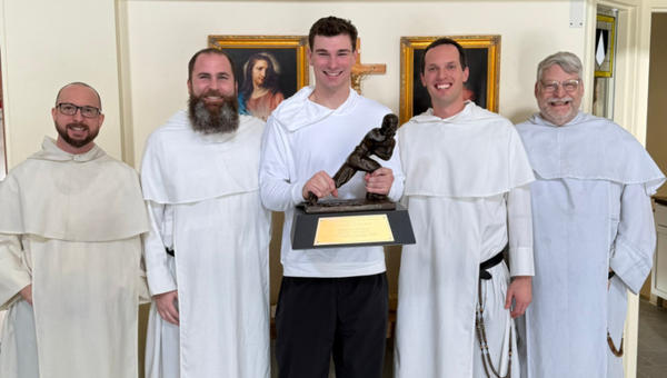 Heisman winner Fernando Mendoza surrounded by priests